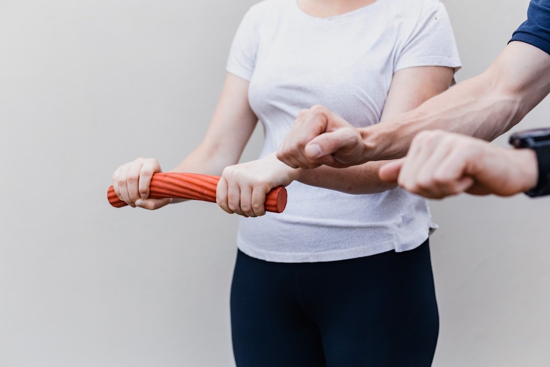 A collection of recovery tools for sore muscles, including foam rollers, massage balls, and resistance bands, arranged aesthetically on a wooden surface.