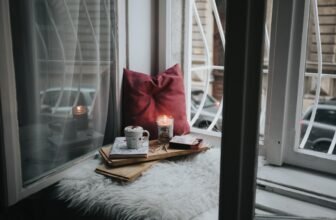 A warm and inviting living room with soft lighting, layered textiles, and indoor plants, creating a calm and comfortable atmosphere.