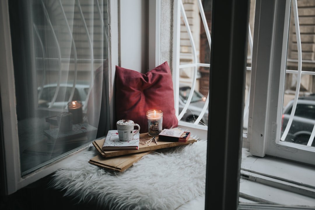 A warm and inviting living room with soft lighting, layered textiles, and indoor plants, creating a calm and comfortable atmosphere.