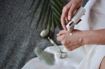 A collection of various skincare tools including cloths, brushes, and electronic devices on a clean, minimalist background.