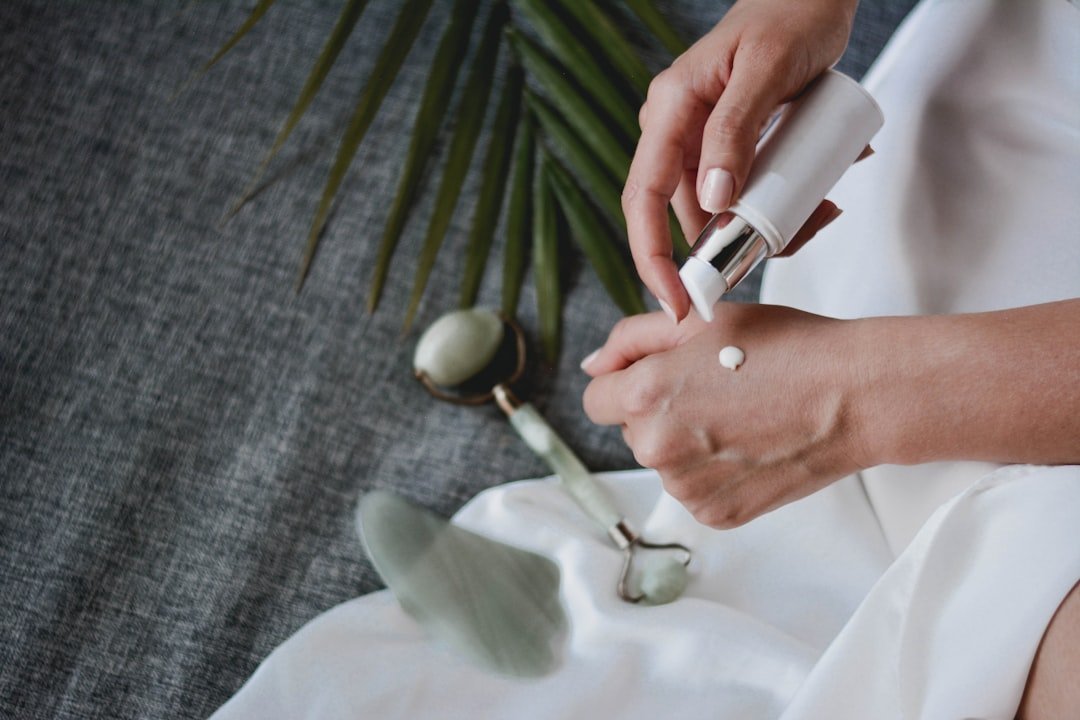 A collection of various skincare tools including cloths, brushes, and electronic devices on a clean, minimalist background.